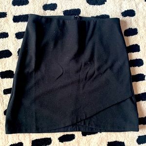 Black, mid-length skirt (hits mid-thigh)